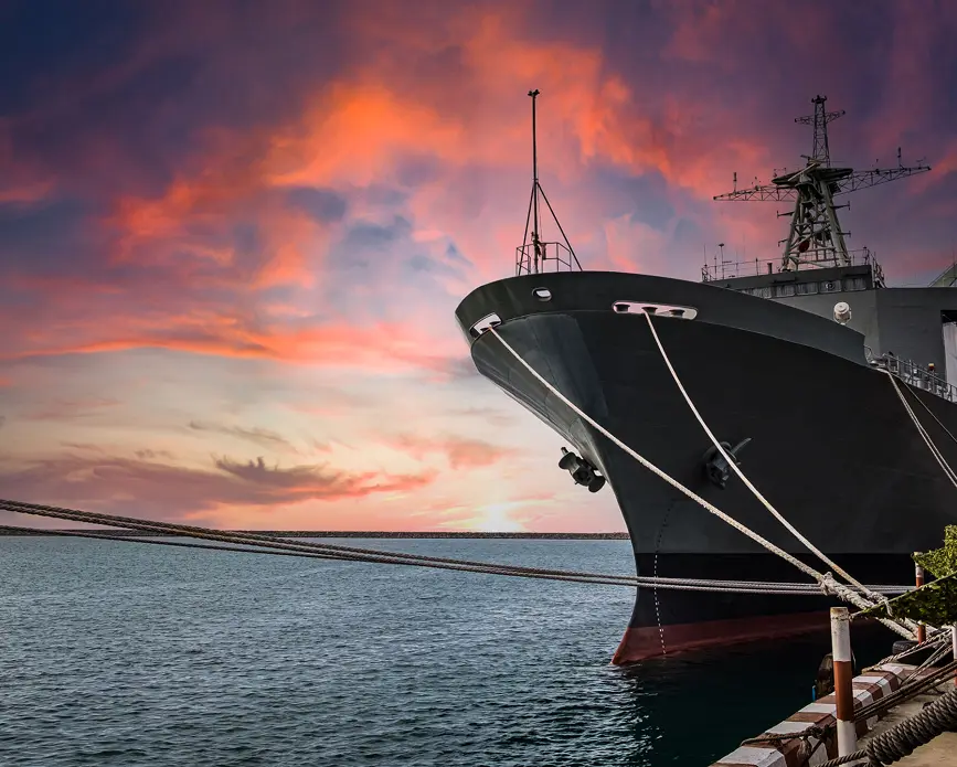 Warship by the harbor at dusk